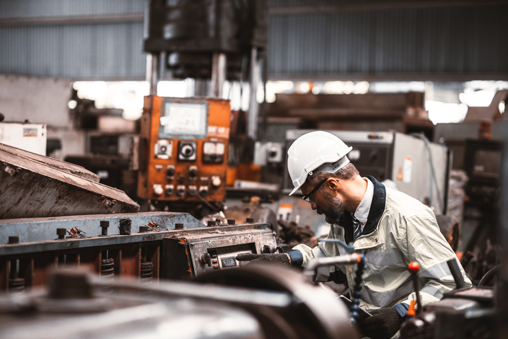 Image of a man working at an industrial machine